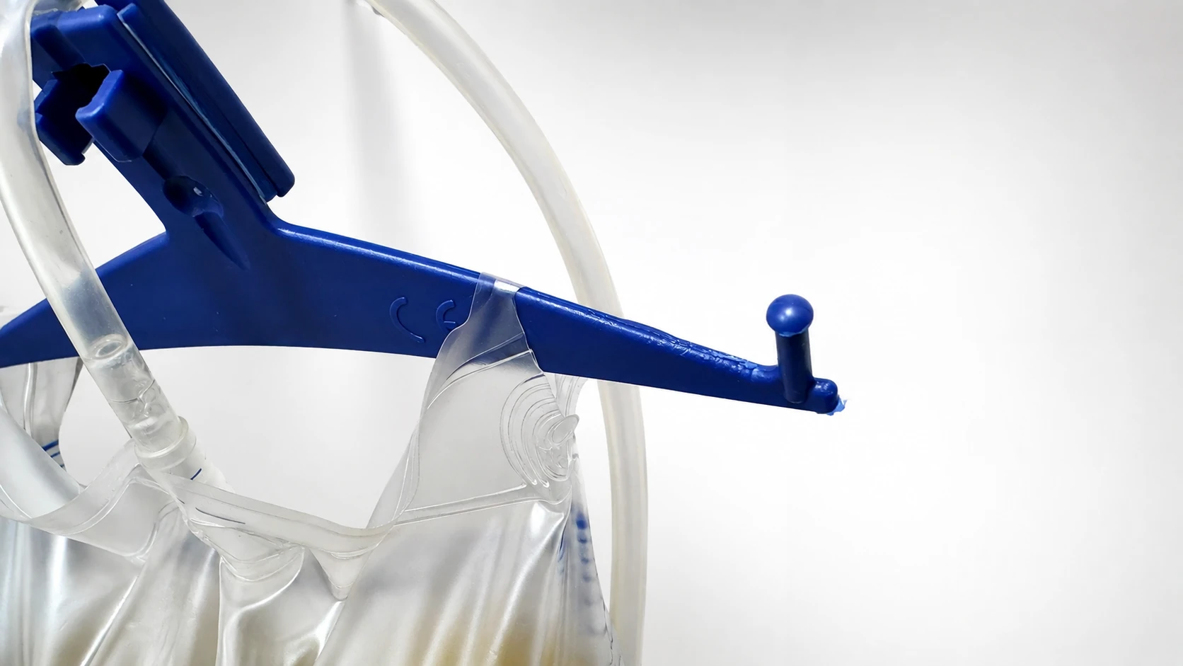 Close view of damage around a urine-bag hanging hole